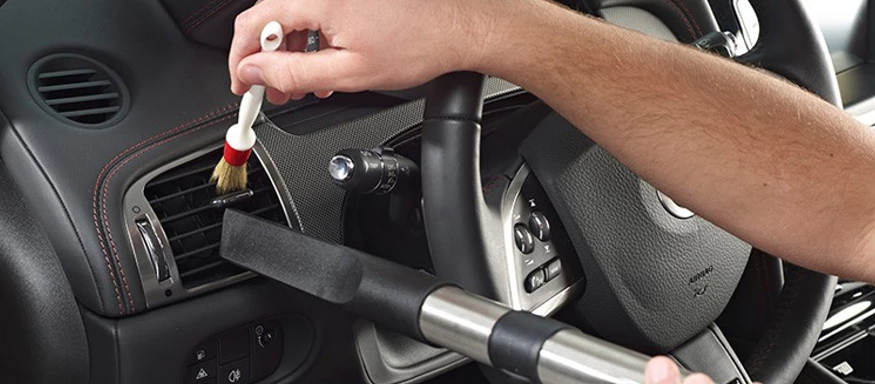 Interior vacuum and dash wipe-down during a mobile wash and vacuum